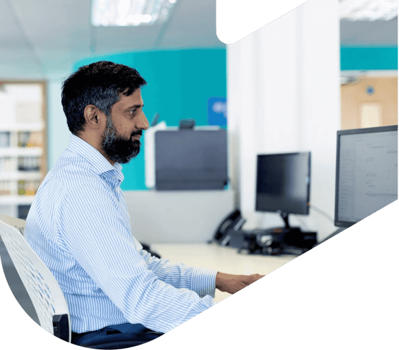 man sitting at computer in an office setting